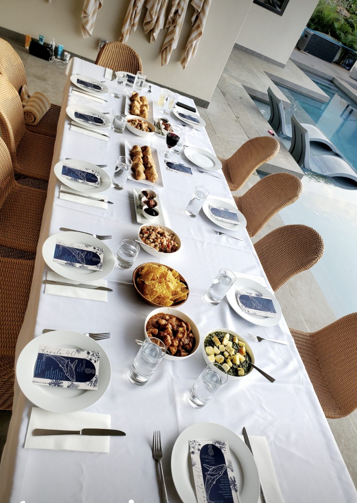 A long table laid with white linen and shared plates