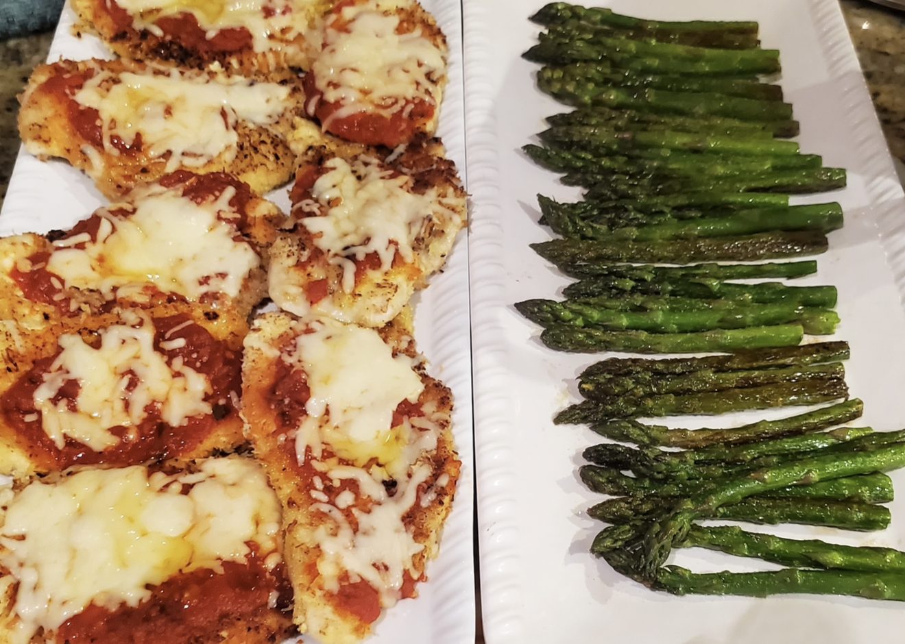Mini parmigiana beside grilled asparagus