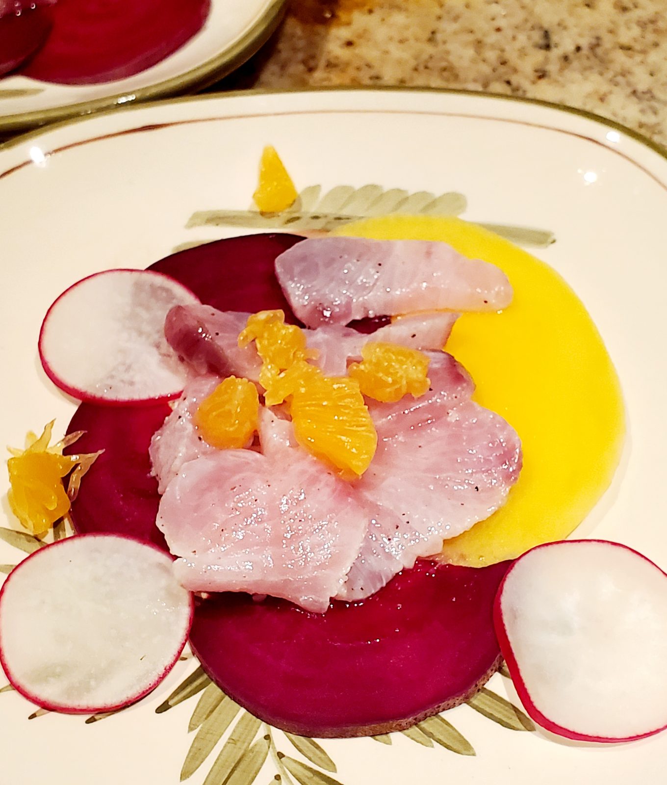 Fresh fish crudo on beetroot with citrus