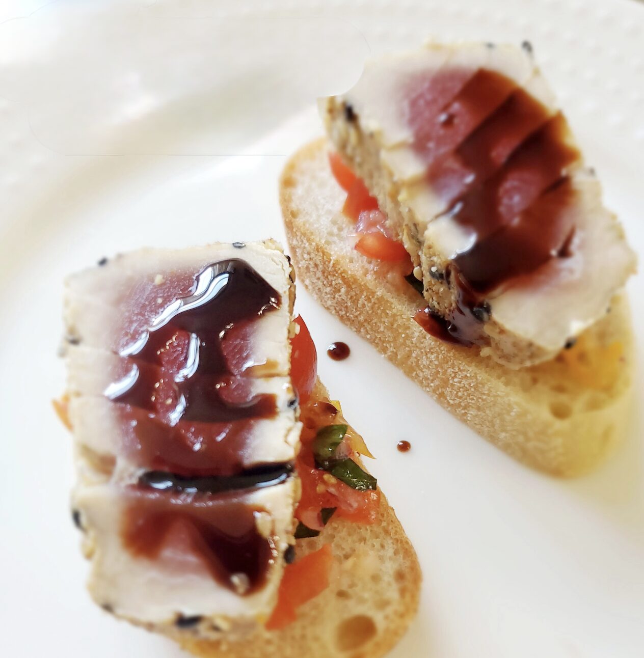 Seared ahi on toasted bruschetta with a balsamic drizzle