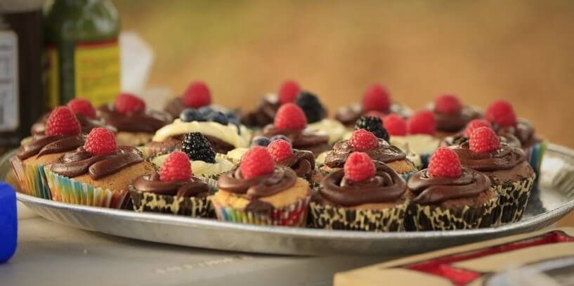 Assorted cupcakes topped with fresh berries