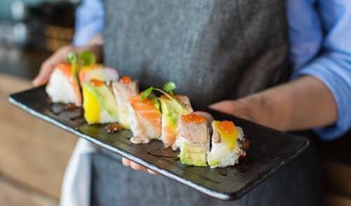 Rainbow sushi roll on a slate tray