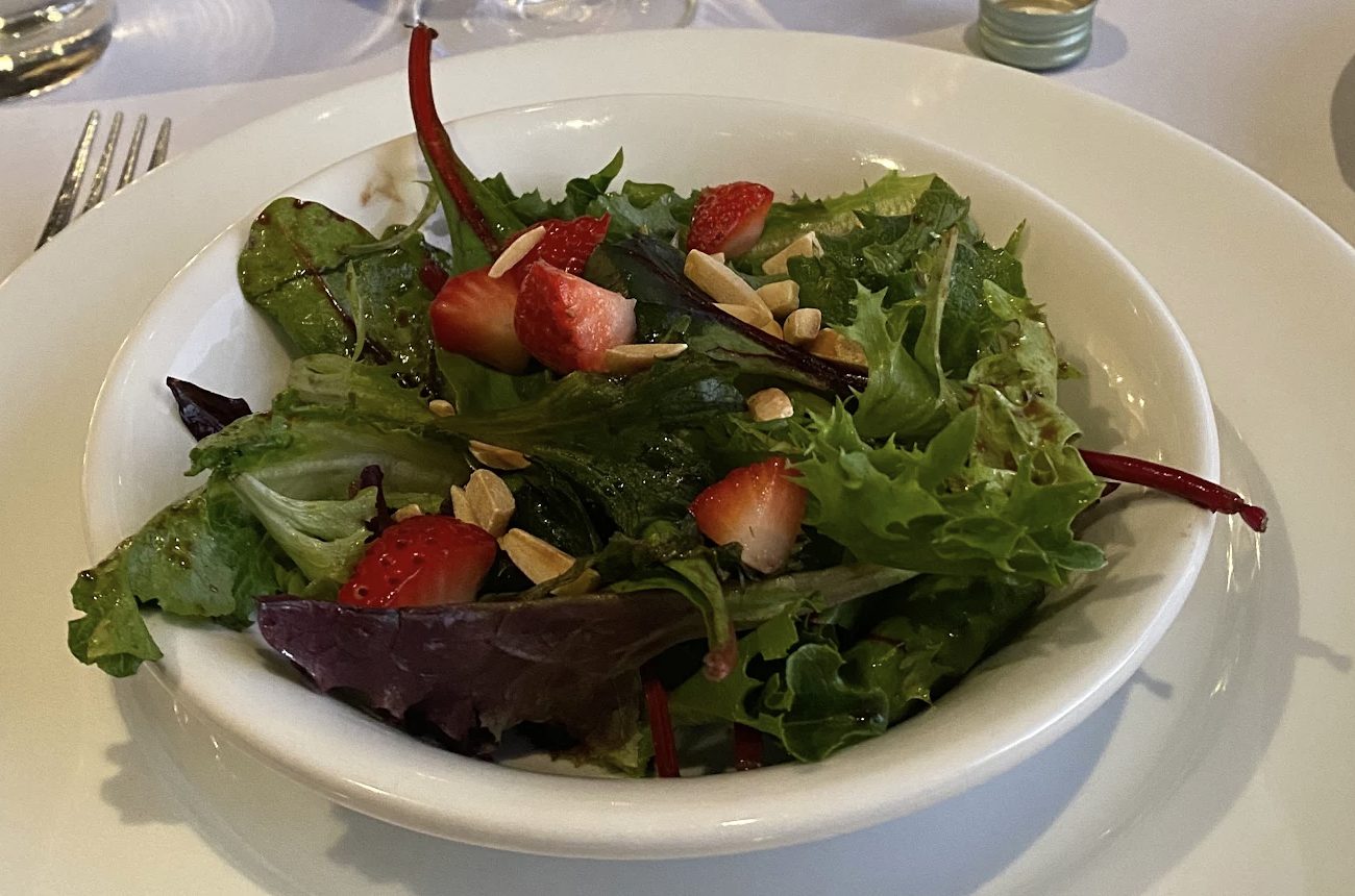 Organic mixed green salad with John's signature balsamic vinaigrette, Kula strawberries and sliced roasted almonds