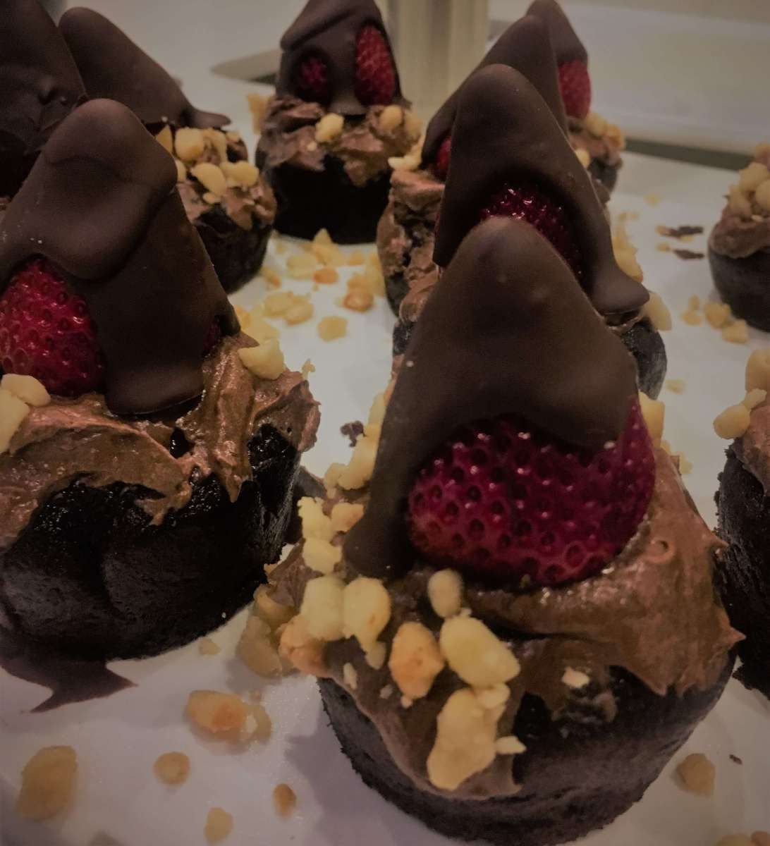 Chocolate-dipped strawberries on mini chocolate cakes